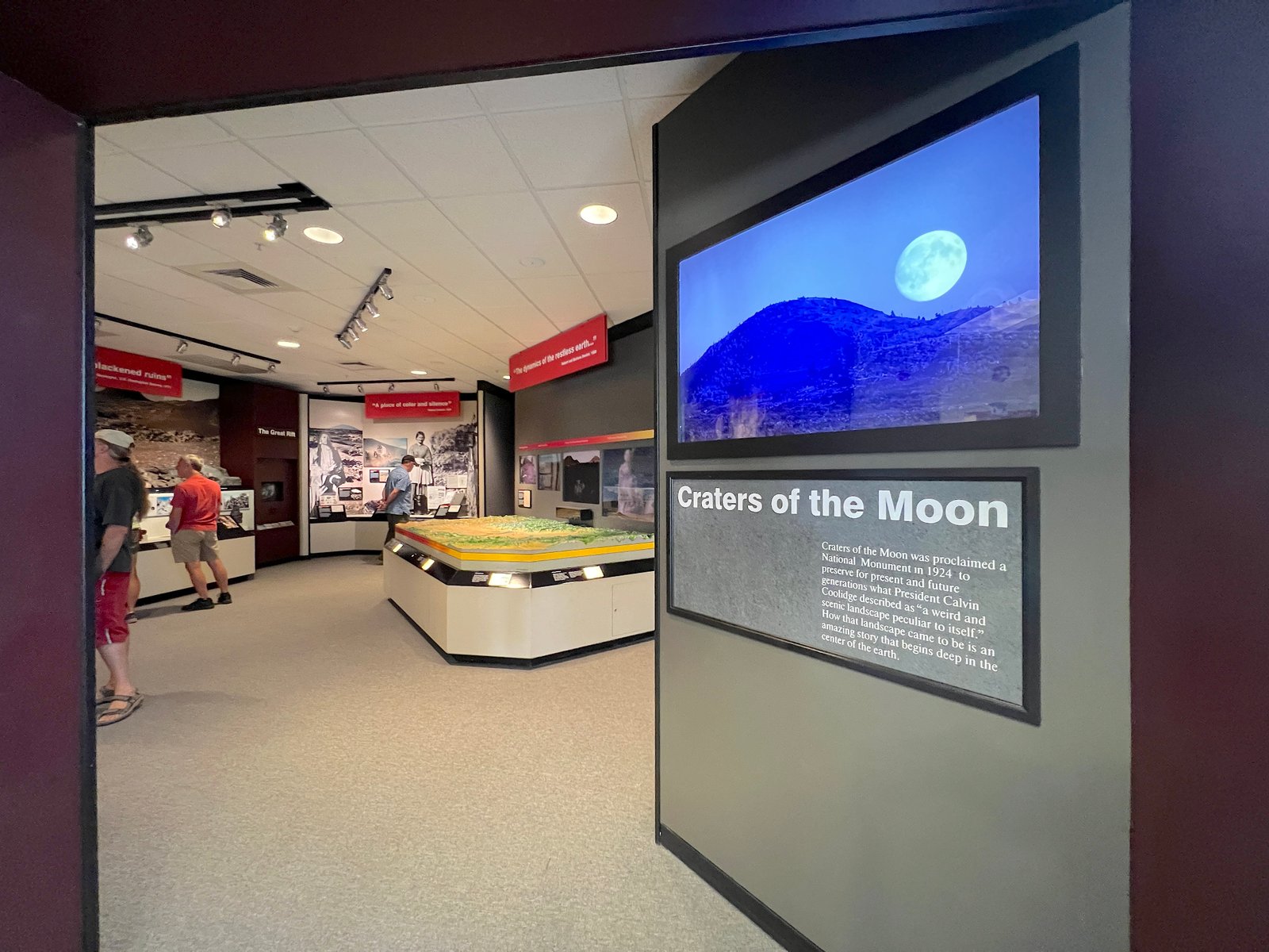 Inside the Robert Limbert Visitor Center featuring educational exhibits and signage at Craters of the Moon National Monument