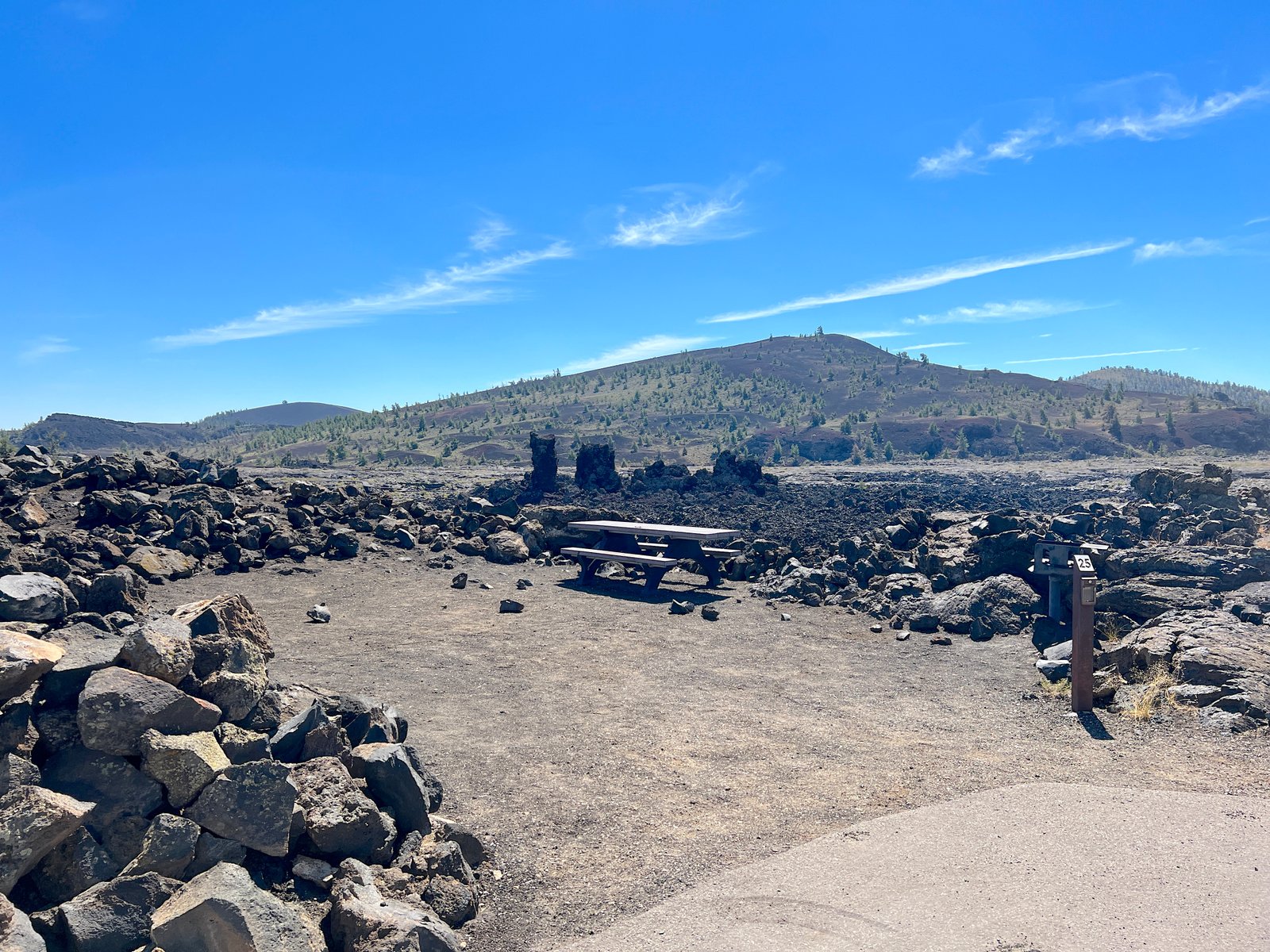 Campsite nestled in dark black volcanic cinder rock at Lava Flow Campground in Craters of the Moon National Monument