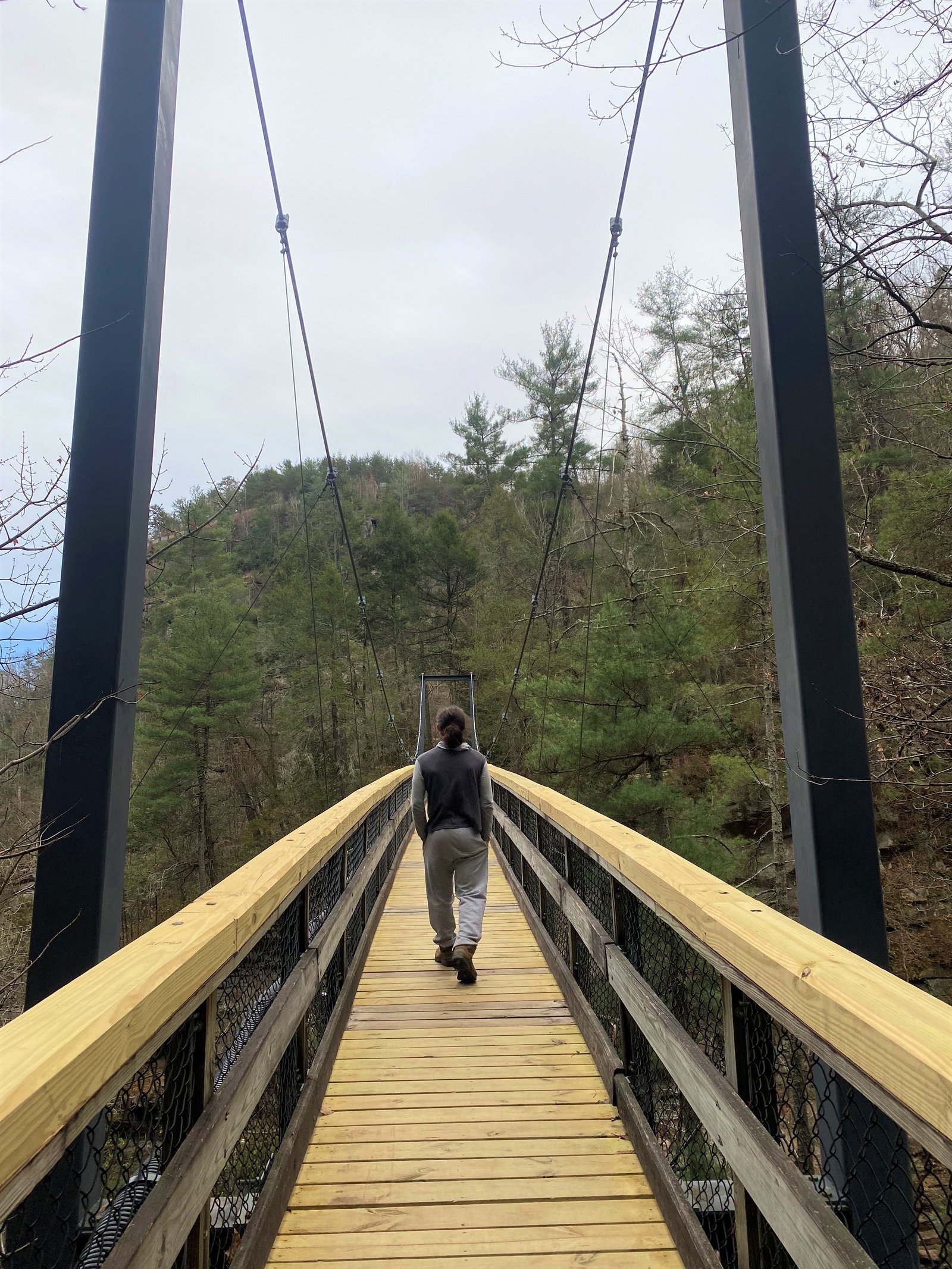 man walking on steel bridge