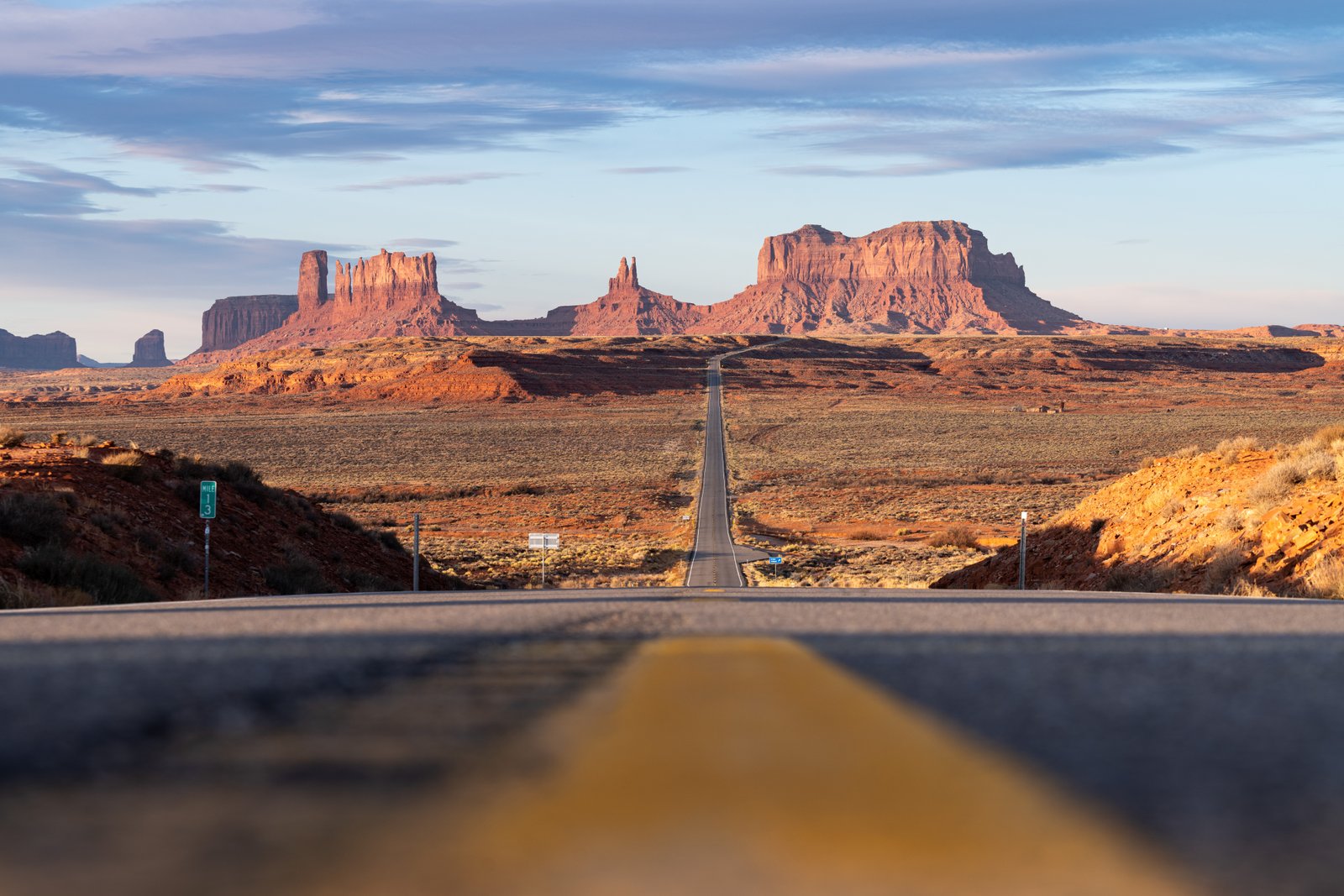 close up of road with red rocks in the distance