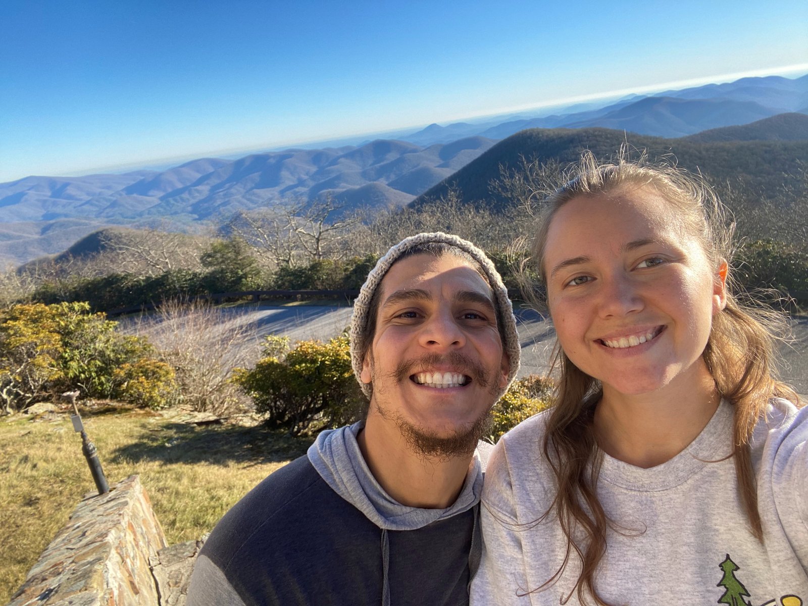 boy and girl posing at the top of summit