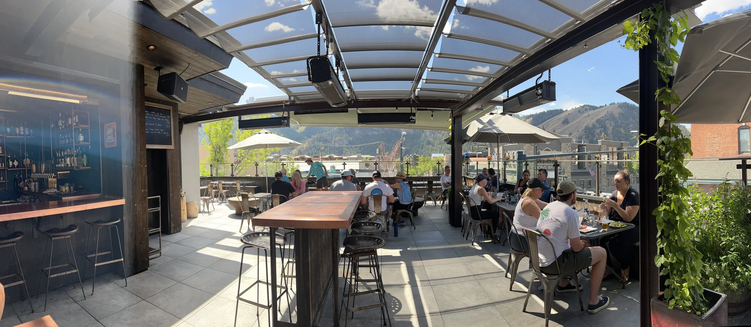 Relaxing under the covered rooftop patio bar at Warfield Distillery and Brewery in Ketchum, Idaho.
