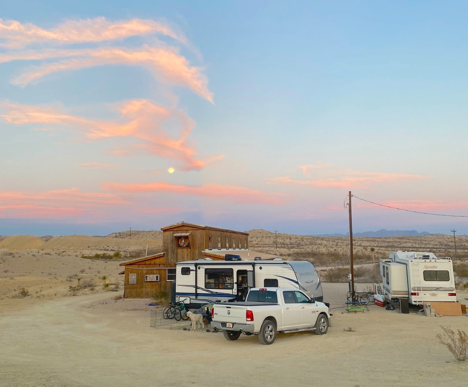 Travel trailer RV campsite setup parked at Dino Ranch with views of the surrounding West Texas desert landscape near Lajitas.
