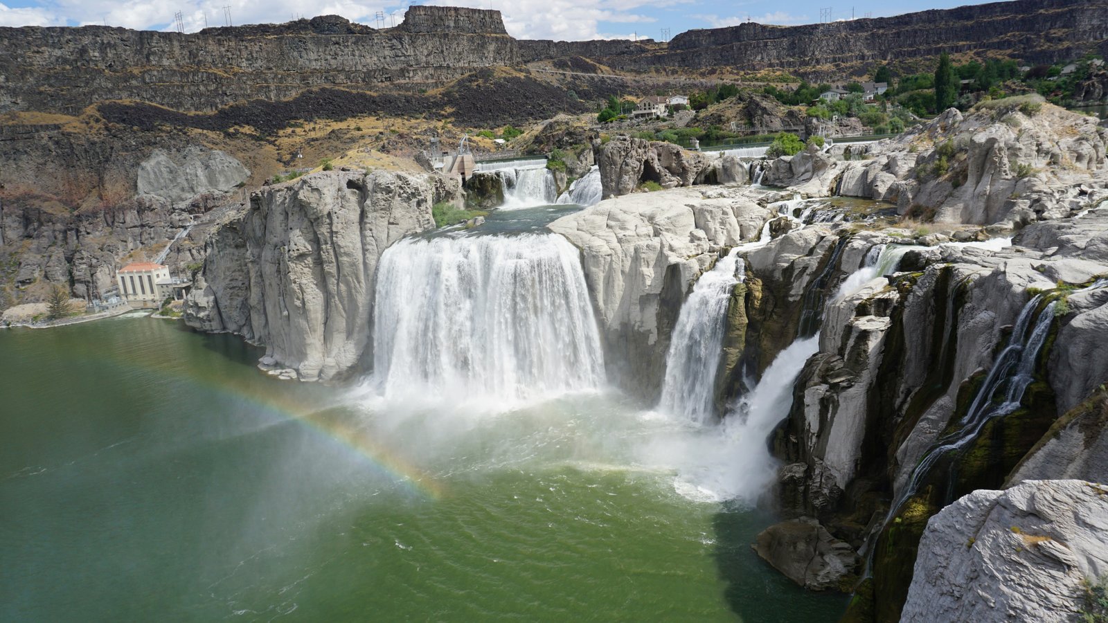 Panoramic view of the powerful Shoshone Falls plunging into the Snake River Canyon with tourists at the overlook in Twin Falls, Idaho.