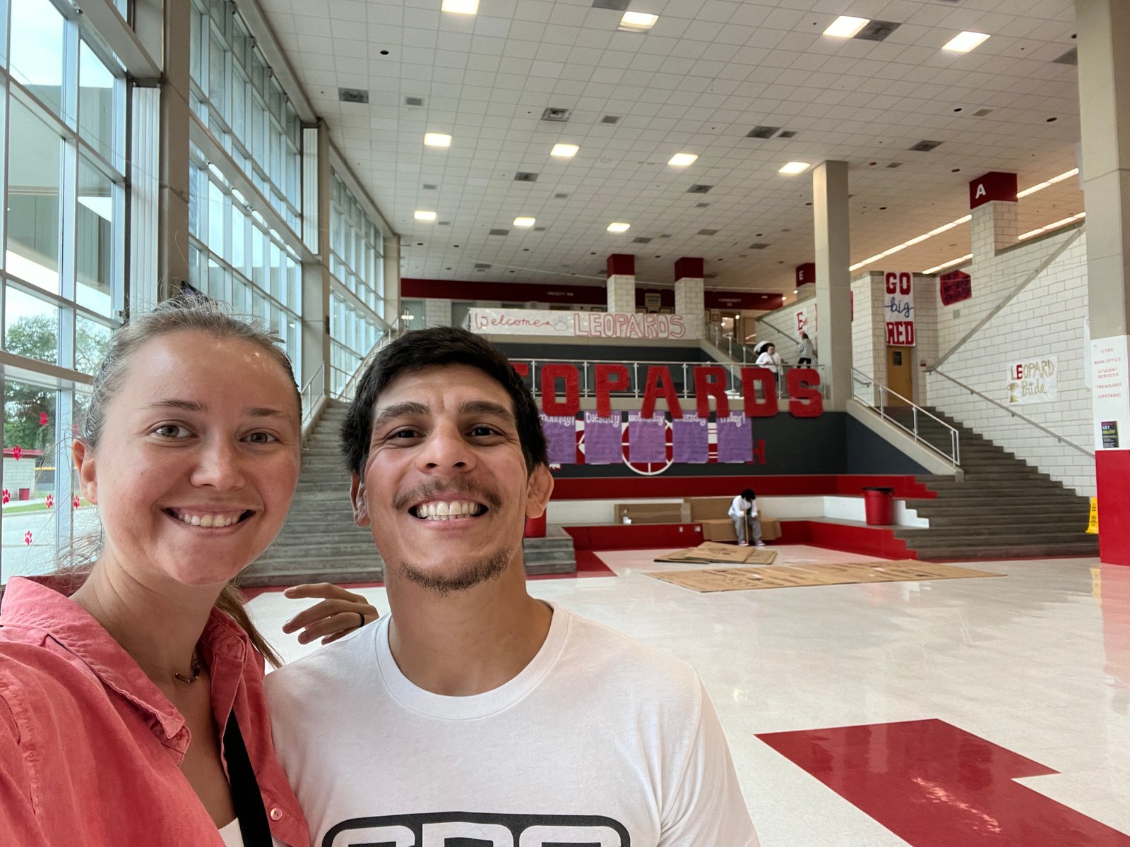 The travel bloggers smiling together for a selfie inside the historic hallways of East High School in Salt Lake City during their self-guided tour.