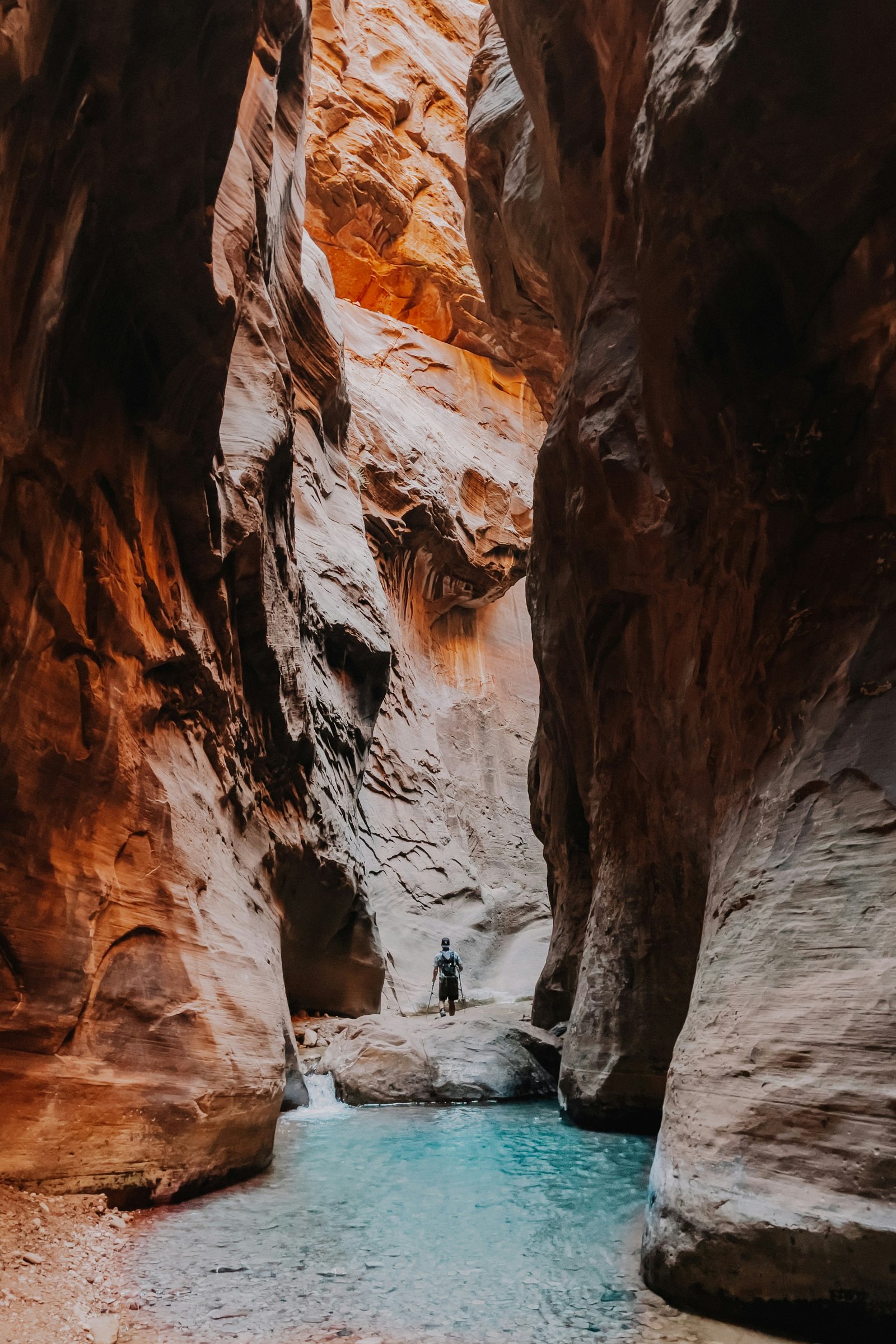 A dramatic view looking up between the narrow, towering sandstone walls of The Narrows in Zion National Park.