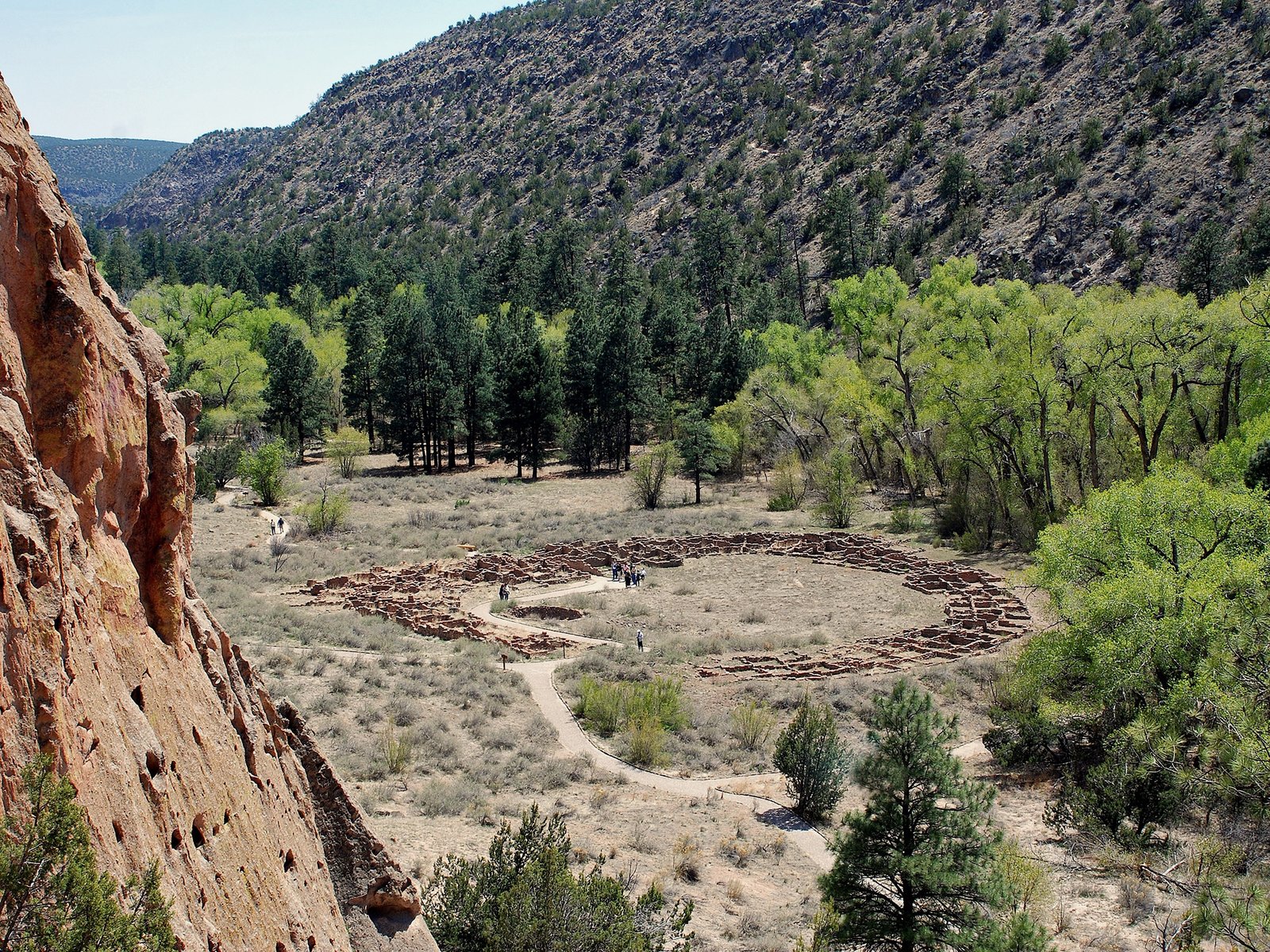 View looking down from the elevated Main Loop Trail at the ancestral Pueblo ruins nestled in Frijoles Canyon at Bandelier National Monument.