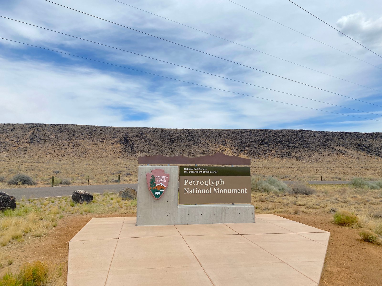 Wooden official National Park Service entrance sign at Petroglyph National Monument in Albuquerque, New Mexico.