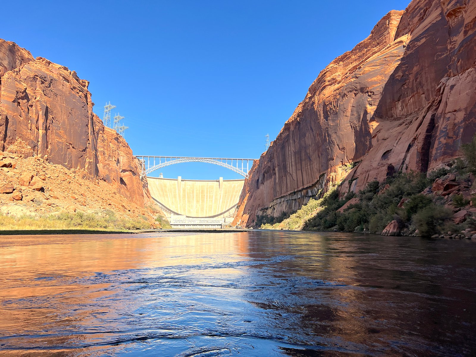 view of the glen canyon dam from the river