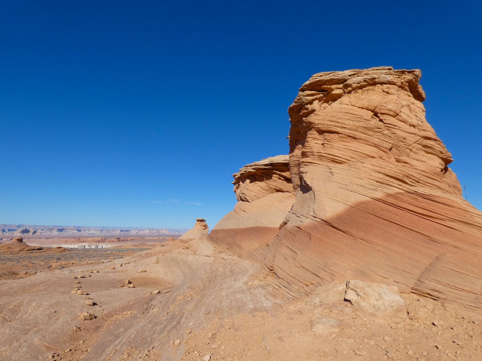photo of orange sandstone columns below blue sky