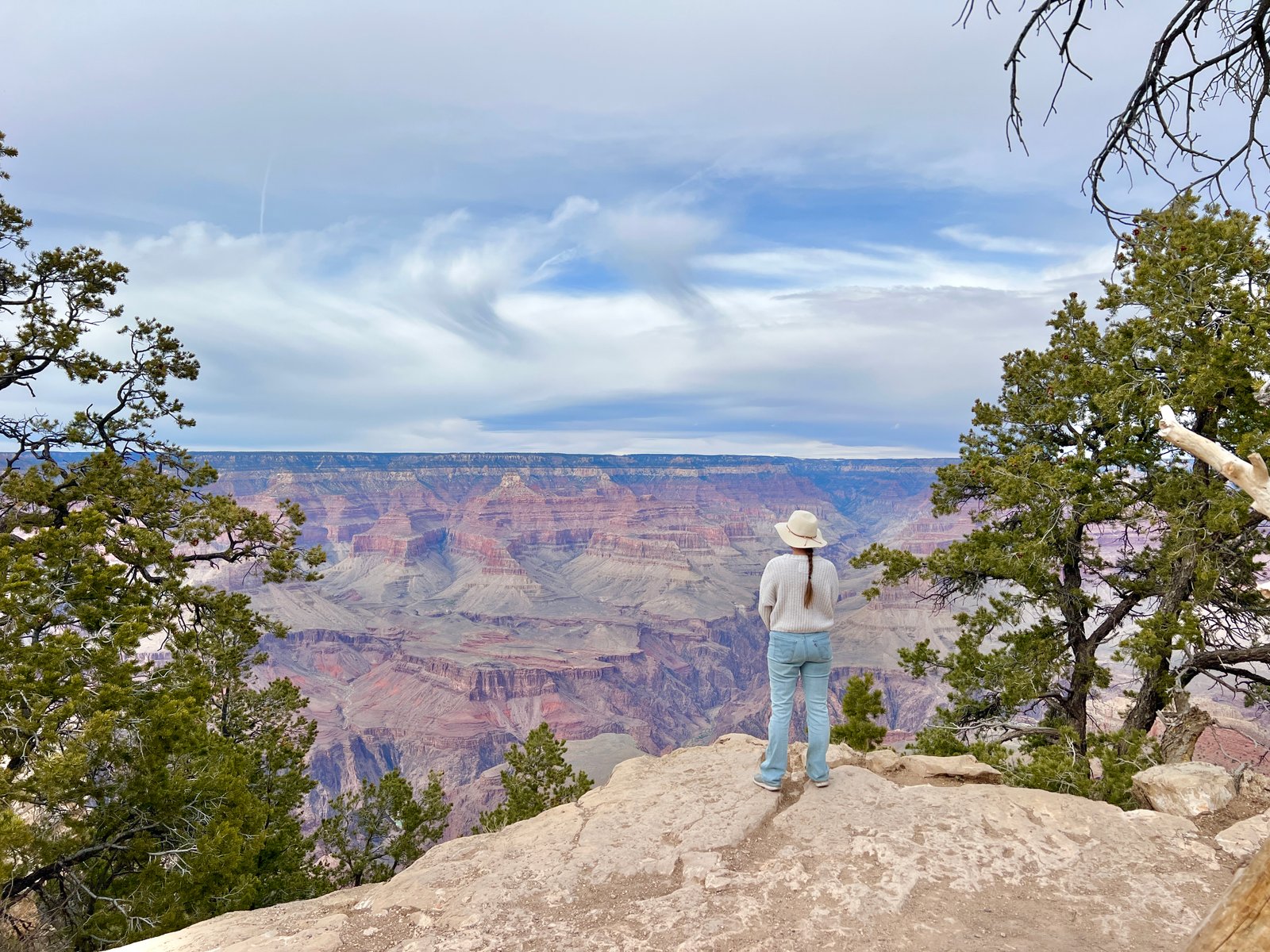 person standing looking out at the Grand Canyon