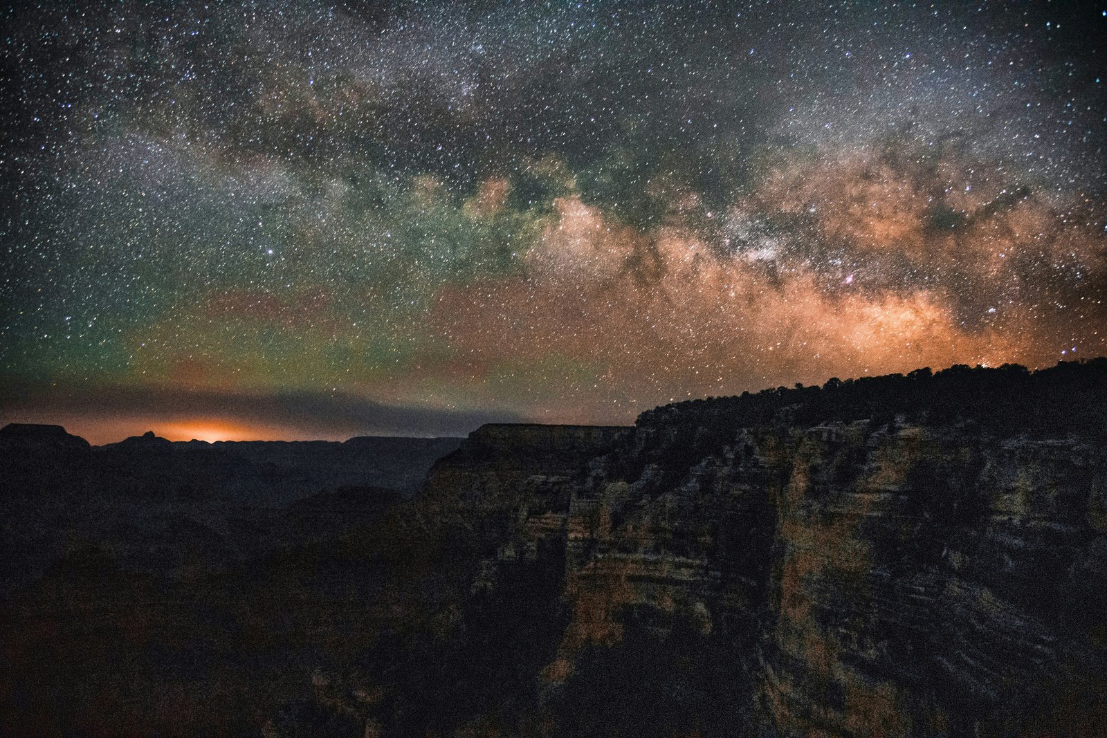 the Milky Way over the cliff edge of the Grand Canyon