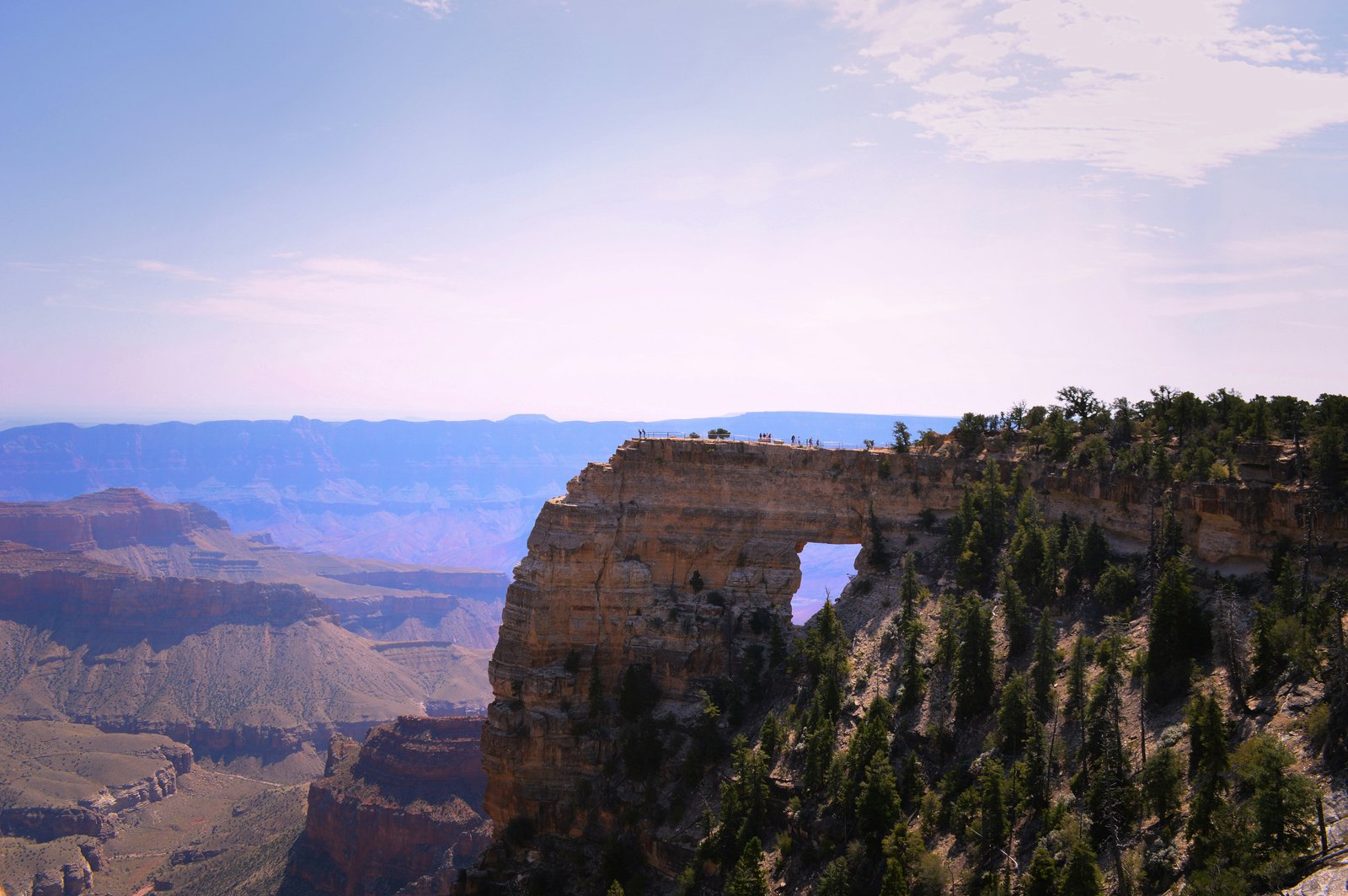 picture of people at overlook in the distance with grand canyon in background