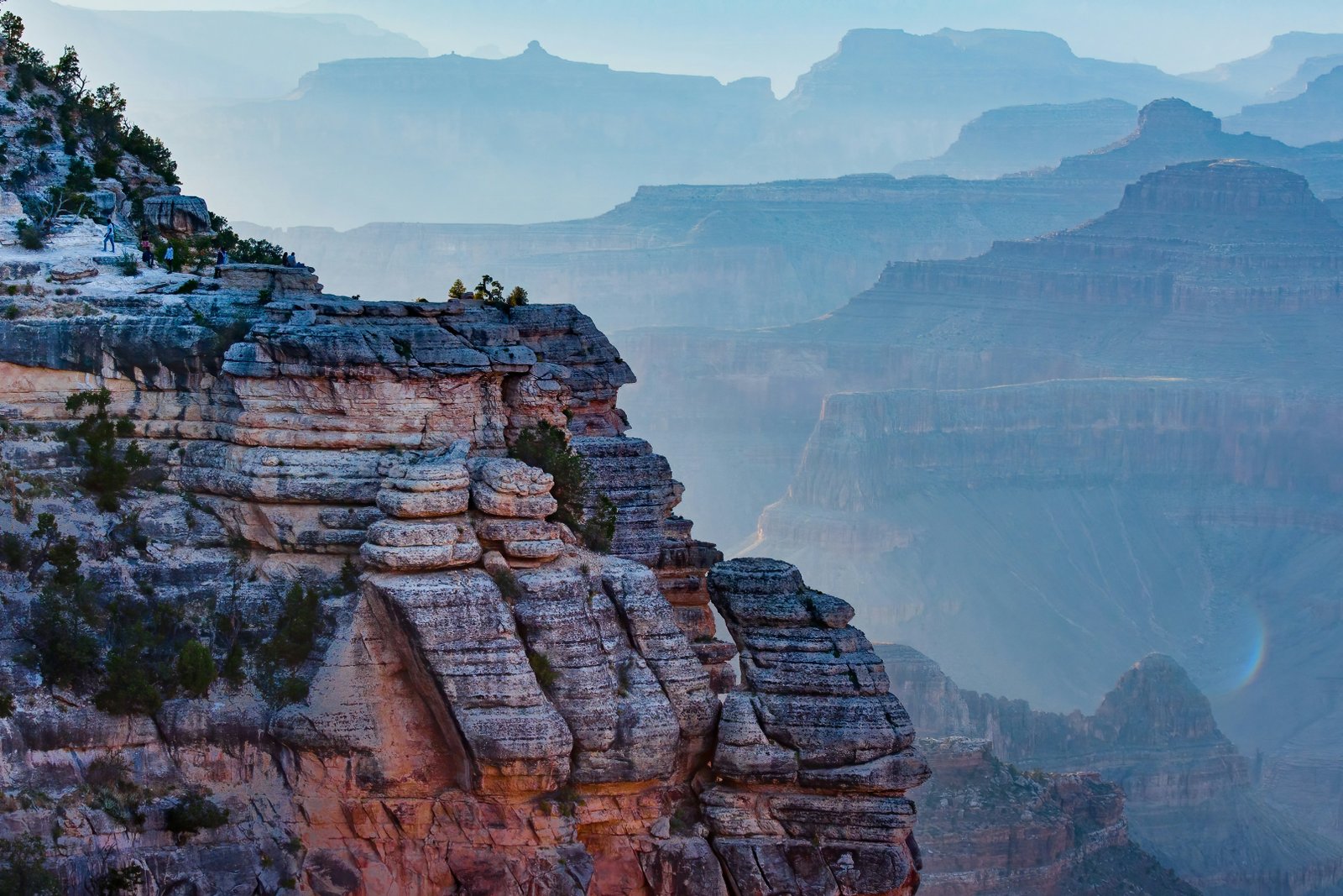 view of rocky cliff and Grand Canyon in the distance