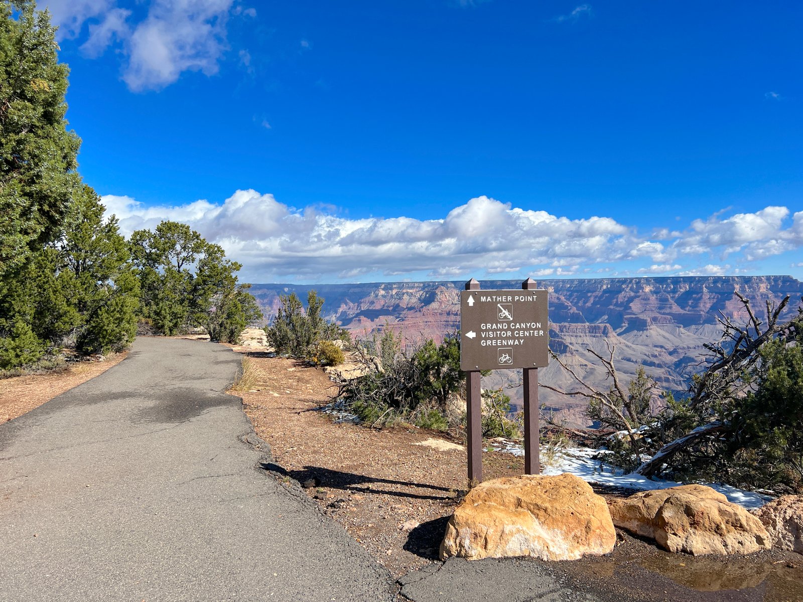 photo of path, sign, and blue sky