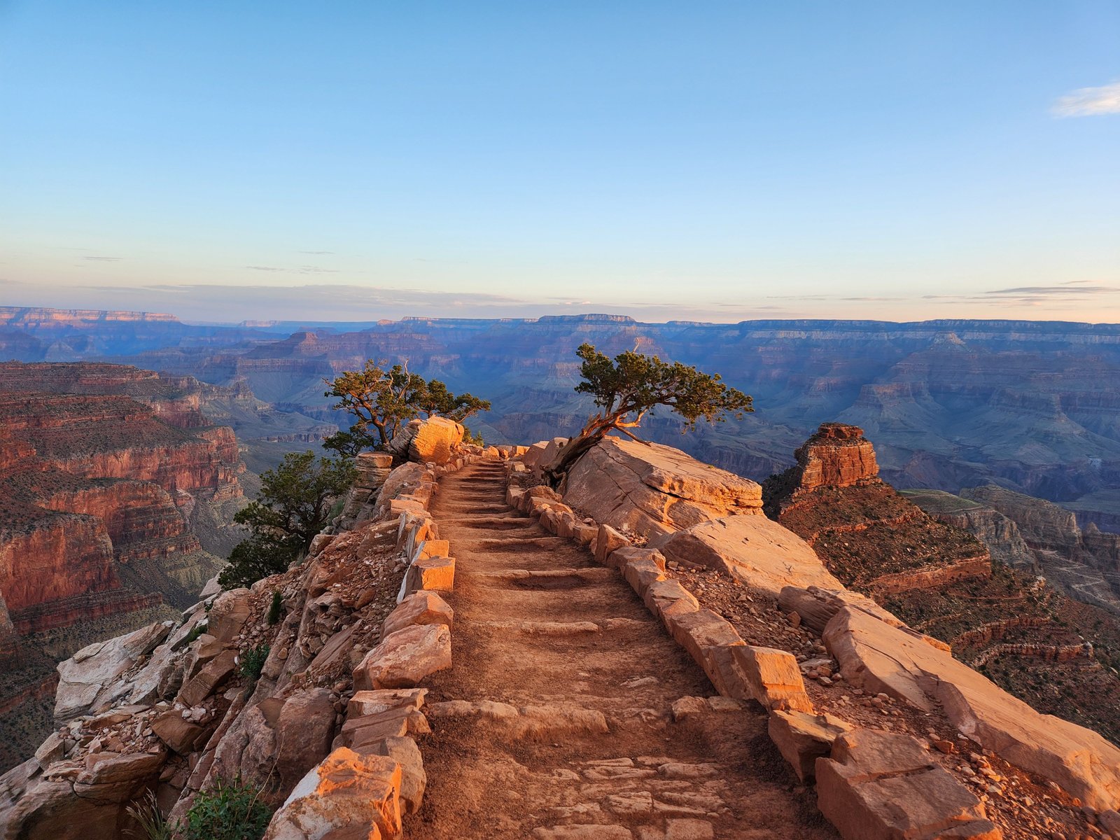 view of empty trail with Grand Canyon in the distance